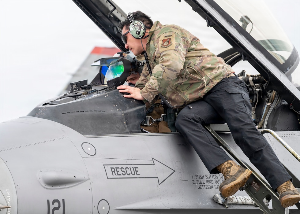 A U.S. Air Force F-16 Fighting Falcon pilot and maintainer run through a preflight checklist during RED FLAG-Alaska 26-1 at Eielson Air Force Base, Alaska, April 20, 2026.