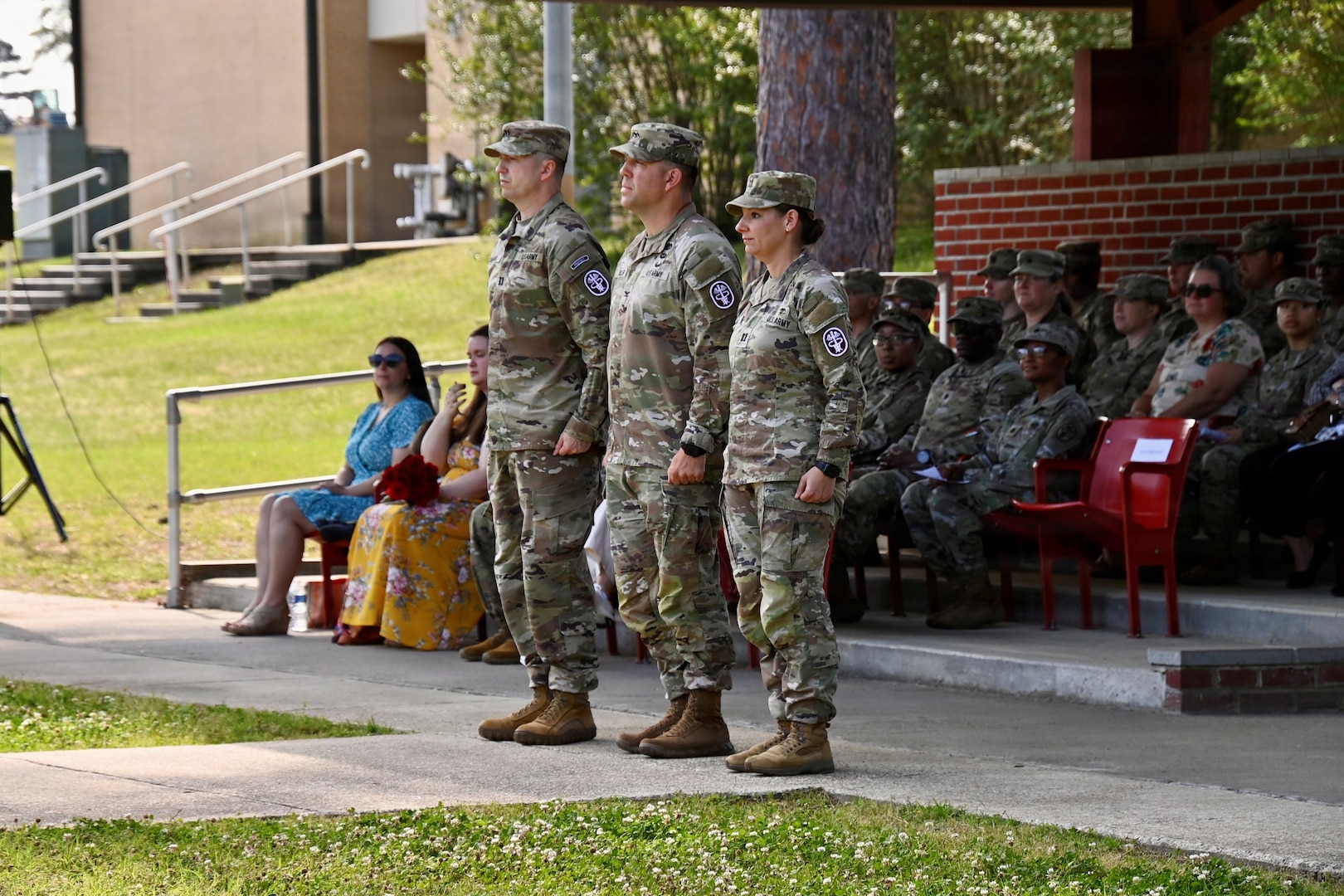 Hospital commander (center) prepares to take the field with the outgoing (left) and incoming (right) company commanders during a change of command ceremony.