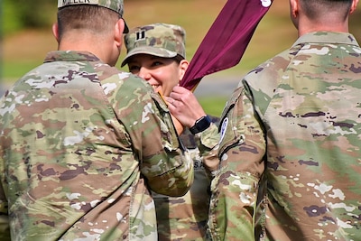 New Medical Company commander takes the guidon from the hospital commander during a change of command ceremony.