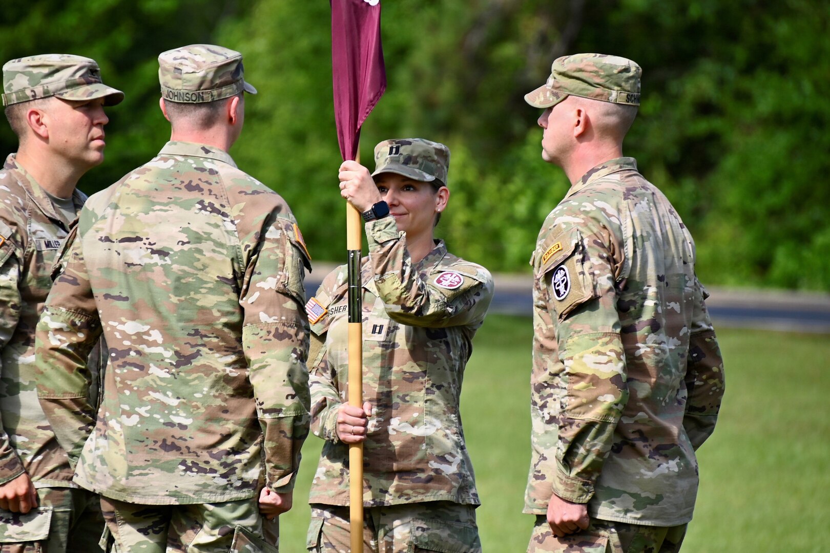 New Medical Company commander holds the guidon during a change of command ceremony.