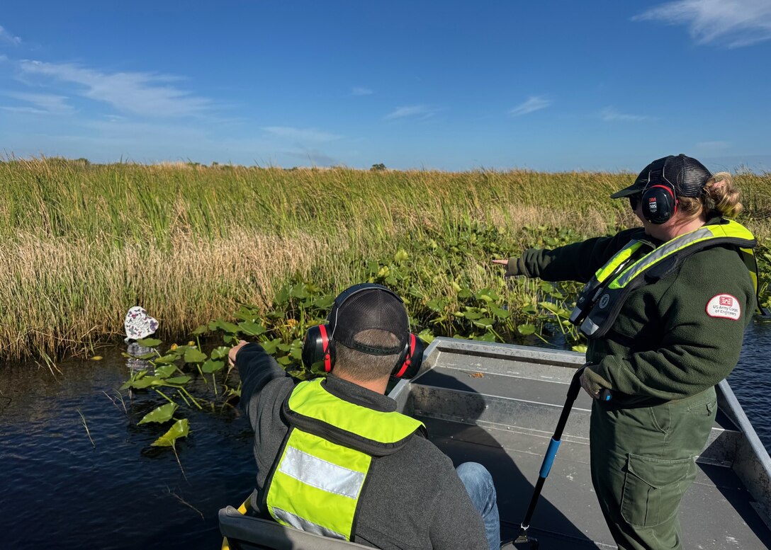 Megan Parsons, left, and Lee Martin identify a floating balloon while conducting a cleanup by airboat on Lake Okeechobee, Florida, April 22, 2026. Balloon debris is a common pollutant that can harm aquatic environments and wildlife. (U.S. Army Corps of Engineers photo)