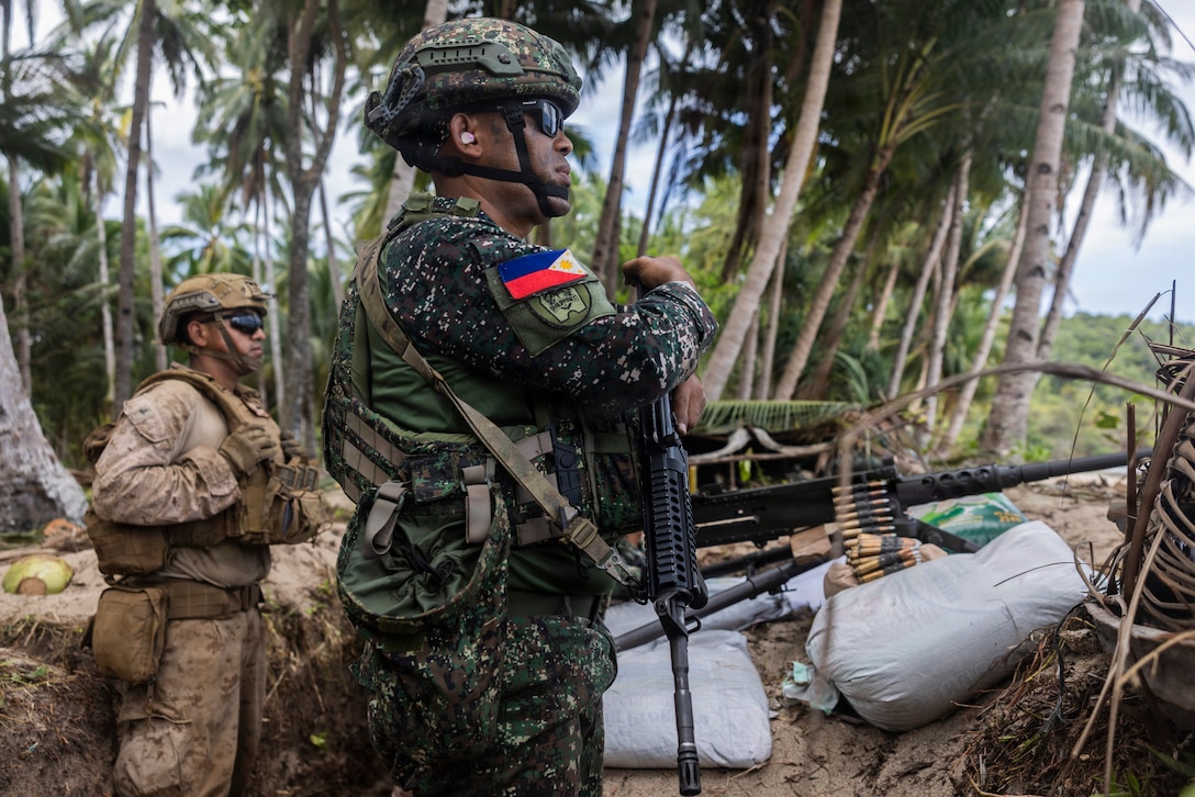 U.S. Marines assigned to 1st Battalion, 5th Marine Regiment, 1st Marine Division, Marine Rotational Force – Darwin, and Philippine marines stand by to engage during a counter-landing live-fire exercise as part of Exercise Balikatan 2026 in Aporawan, Philippines, April 27, 2026.