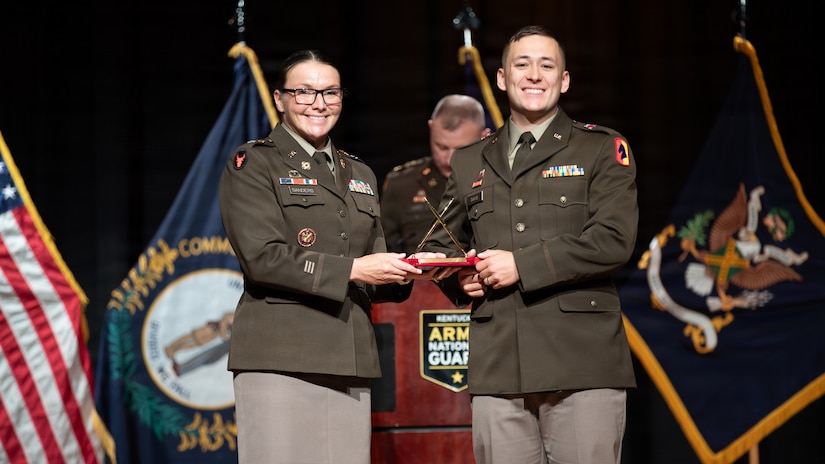 U.S. Army Lt. Col. Dayna Sanders, commander of the 103rd Brigade Support Battalion and president of the National Guard Association of Kentucky, presents Officer Candidate Cody Davis with the Officer Candidate School Academic Award during the Officer Candidate School Class 68-26 graduation at the Kentucky State University David H. Bradford Hall Auditorium in Frankfort, Kentucky, April 18, 2026.