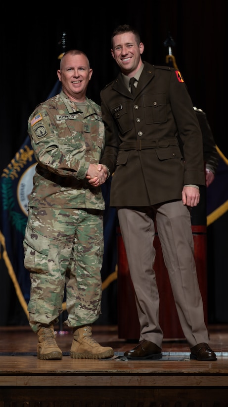U.S. Army Master Sgt. Hatfield (left) receives a silver dollar coin following 2nd Lt. Jacob Wilson’s first salute (right) during the Officer Candidate School Class 68-26 graduation ceremony at Kentucky State University’s David H. Bradford Hall Auditorium in Frankfort, Kentucky, April 18, 2026.