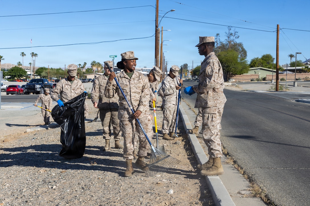 U.S. Marines with headquarters battalion, Marine Corps Air Ground Combat Center, Marine Air Ground Task Force Training Command rake and collect trash for Operation Clean Sweep on MCAGCC, Twentynine Palms, California, April 14, 2026. Operation Clean Sweep demonstrates a collective commitment to improving living conditions through shared ownership, sustained accountability, and tangible improvements to the barracks and base facilities. (U.S. Marine Corps photo by Lance Cpl. Jozef P. Majewski)