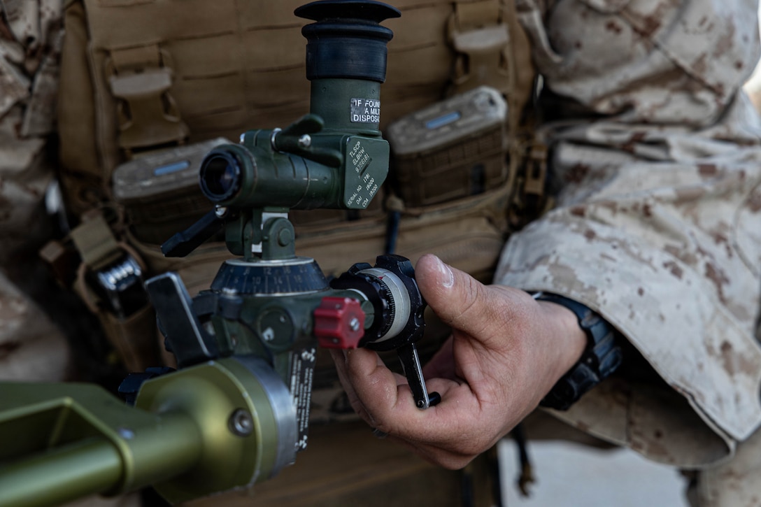 U.S. Marine Corps Cpl. Jordan Schneider, a Wyoming native, mortarman with 1st Battalion, 2nd Marine Regiment, 2nd Marine Division, adjusts the sighting system of a M224 60mm mortar at range 106, Marine Corps Air Ground Combat Center, Twentynine Palms, California, April 1, 2026. Mortar teams work together to coordinate mortar strikes, supporting other units with indirect fire to accomplish the mission. (U.S. Marine Corps photo by LCpl. Cody Fitzgerald)