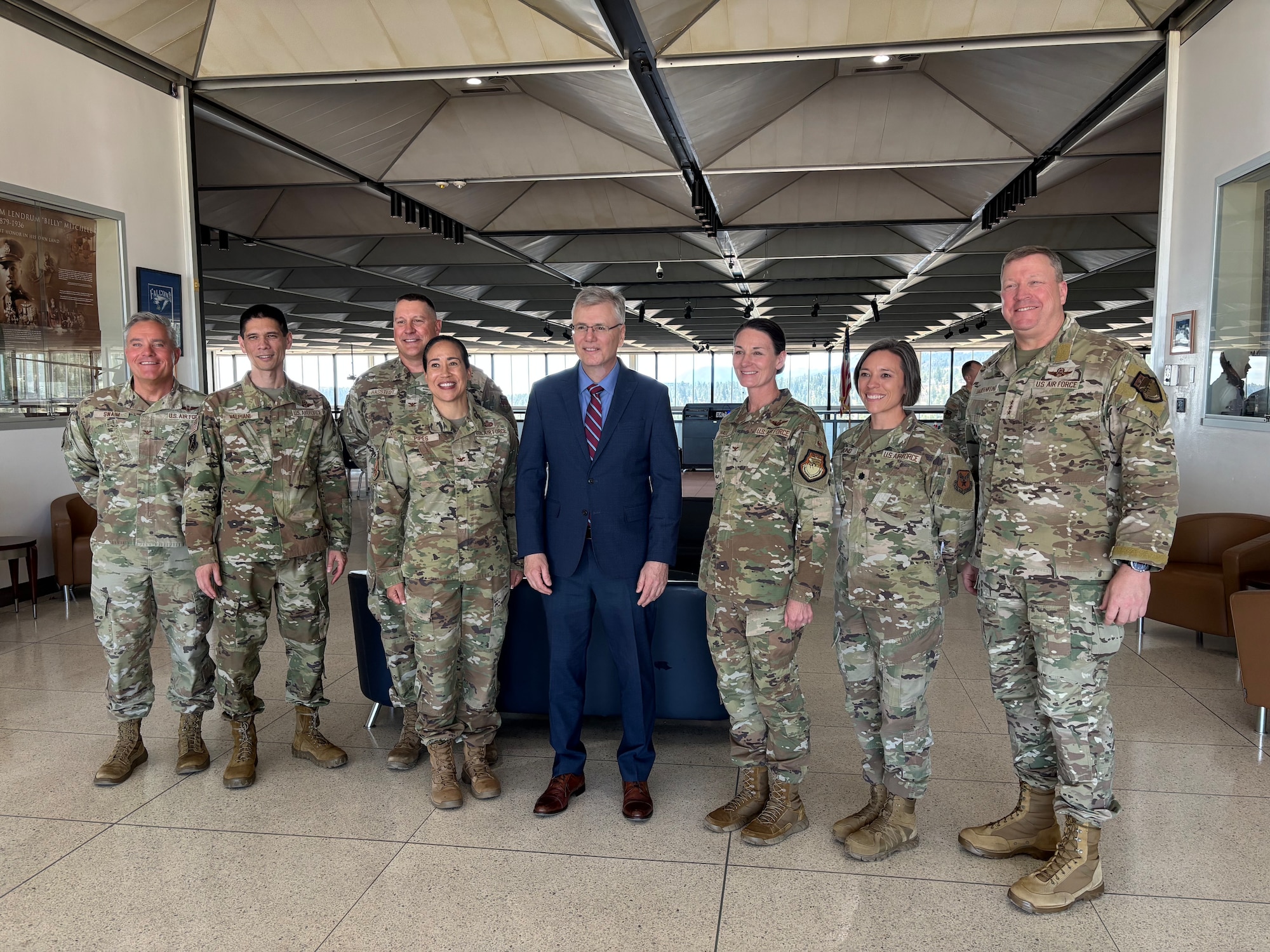 A group of Airmen pose for a photo with the Secretary of the Air Force.