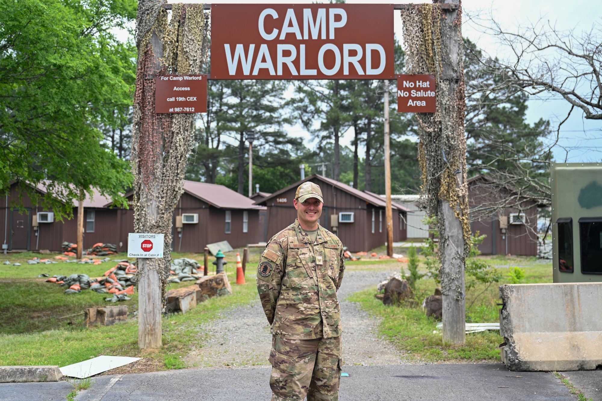 A man stands in front of "War Center" sign.