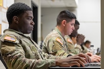2nd Lt. Aquoi Alexander, 125th Finance Battalion Bravo Company platoon leader, left; Spc. Jonathan Hernandez, 125th FIBN cashier, center; and Sgt. Boris Ilboudo, 125th FIBN early entry team certifier, take part in a two-hour essay writing exercise at Fort Jackson, S.C., April 21, 2026. Twelve finance and comptroller Soldiers wrote essays as part of the U.S. Army Finance Corps’ annual Finance Soldier of the Year competition. (U.S. Army photo by Mark R. W. Orders-Woempner)
