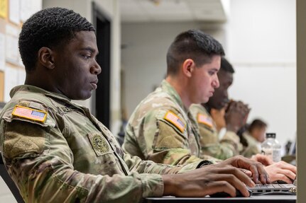 2nd Lt. Aquoi Alexander, 125th Finance Battalion Bravo Company platoon leader, left; Spc. Jonathan Hernandez, 125th FIBN cashier, center; and Sgt. Boris Ilboudo, 125th FIBN early entry team certifier, take part in a two-hour essay writing exercise at Fort Jackson, S.C., April 21, 2026. Twelve finance and comptroller Soldiers wrote essays as part of the U.S. Army Finance Corps’ annual Finance Soldier of the Year competition. (U.S. Army photo by Mark R. W. Orders-Woempner)