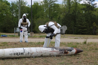 U.S. Army Sgt. Timothy Ix, left, and Staff Sgt. Tyler Orvick, both representing the 716th Explosive Ordnance Disposal Company, 303rd EOD Battalion, the 8th Military Police Brigade and U.S. Army Pacific, collecting data with the Spectral Radiation Monitor-50