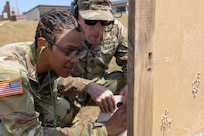 Capt. Bethani Glover-Greaves, 18th Finance Battalion Alpha Company commander, marks her target at as she zeroes in her M4 carbine as Sgt. 1st Class Terry Johnson, U.S. Army Finance and Comptroller School senior training analyst, provides guidance at Fort Jackson, S.C., April 22, 2026. Twelve finance and comptroller Soldiers took their best shots as part of the U.S. Army Finance Corps’ annual Finance Soldier of the Year competition. (U.S. Army photo by Mark R. W. Orders-Woempner)