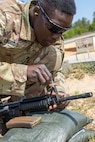 Sgt. Boris Ilboudo, 125th Finance Battalion early entry team certifier, makes adjustments to his M4 carbine at Fort Jackson, S.C., April 22, 2026. Twelve finance and comptroller Soldiers took their best shots as part of the U.S. Army Finance Corps’ annual Finance Soldier of the Year competition. (U.S. Army photo by Mark R. W. Orders-Woempner)