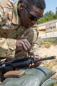 Sgt. Boris Ilboudo, 125th Finance Battalion early entry team certifier, makes adjustments to his M4 carbine at Fort Jackson, S.C., April 22, 2026. Twelve finance and comptroller Soldiers took their best shots as part of the U.S. Army Finance Corps’ annual Finance Soldier of the Year competition. (U.S. Army photo by Mark R. W. Orders-Woempner)