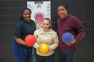 Ashley “Brianna” Jordan, 62d Airlift Wing Integrated Prevention and Resilience Office prevention coordination specialist, left, Stephanie Pileggi, 62d AW IPRO prevention analyst, center, and Darren Powell, 62d AW IPRO director, stand together following the Directorate of Human Resources-Army Substance Abuse Program National Alcohol Awareness Month dodgeball tournament, Joint Base Lewis-McChord, Washington, April 2, 2026.