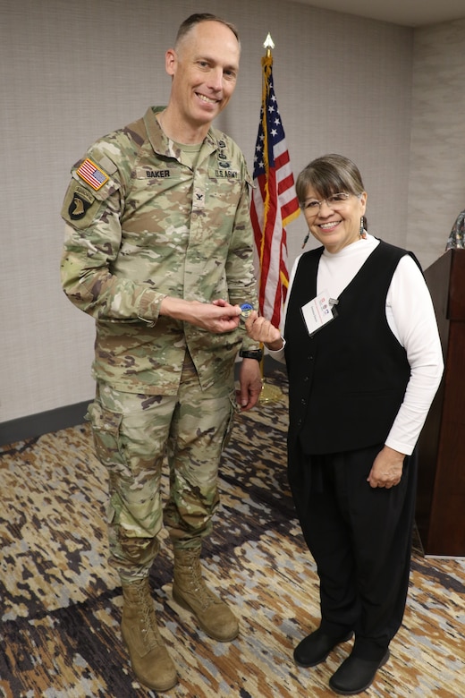 Los Angeles District Commander Col. Andrew Baker and the American Indian Chamber Education Fund APEX Accelerator Program Manager Venessa Gleich, pose during a coin presentation during the spring Business Opportunities Open House, or BOOH, March 18 at the Midtown Hilton Garden Inn in Phoenix. During the BOOH, more than 350 business owners met with the district’s division chiefs, program and project managers.