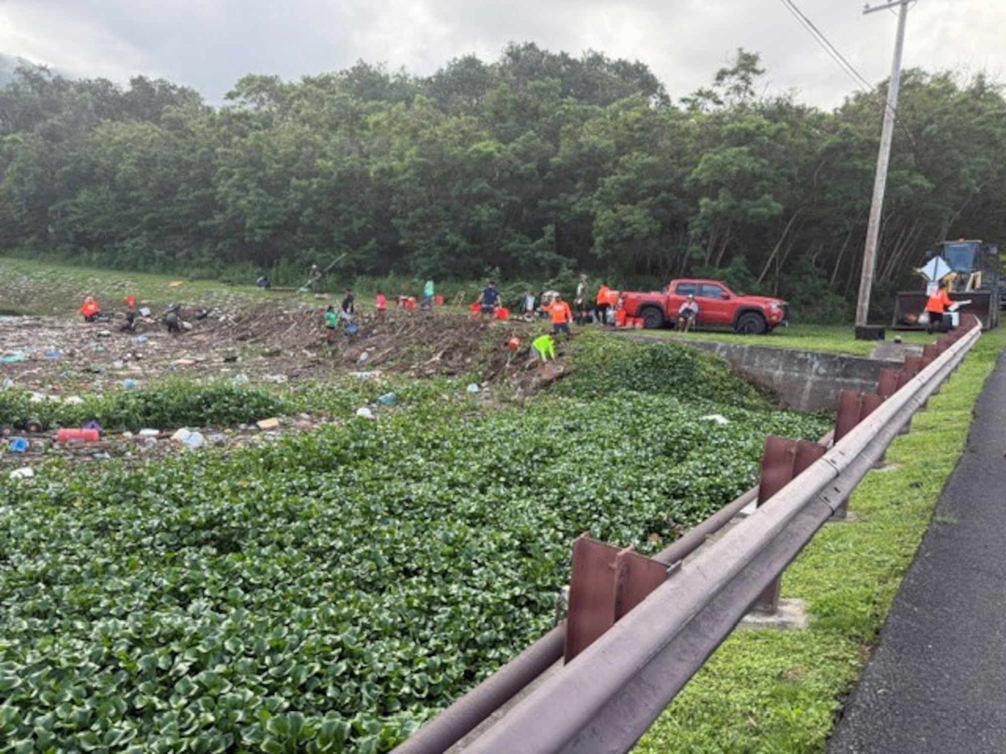 Volunteers from the community at Bellows Air Force Station clear waterways to avoid flooding.