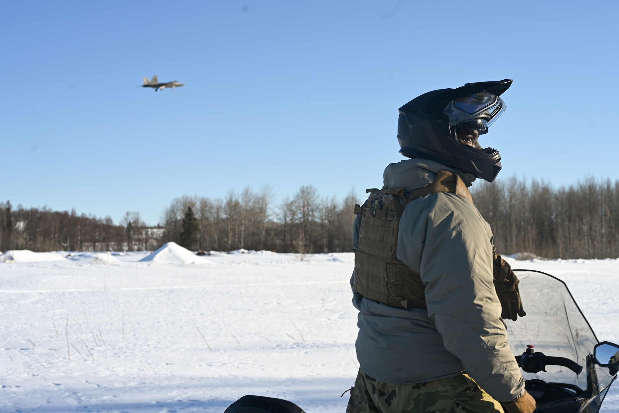 U.S. Air Force Staff. Sgt. Cameron Christopher, a 673d Security Forces Squadron defender, drives a snowmachine during the Arctic Combat Development Course (ACDC)  on Joint Base Elmendorf-Richardson, March. 26, 2026. Snowmachine competency is a cornerstone of ACDC, which seeks to better equip servicemembers for combat scenarios in austere arctic scenarios, further enhancing homeland defense. (U.S. Air Force photo by Airman 1st Class Eli A. Rose)