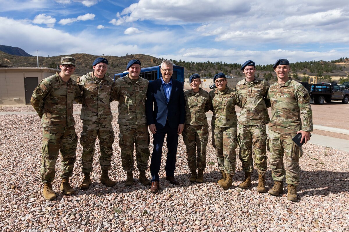 A group of seven cadets pose with the Secretary of the Air Force.