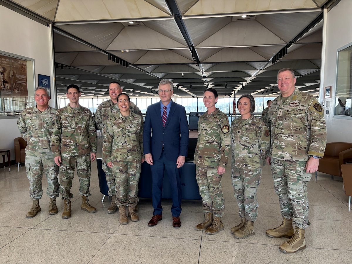 A group of Airmen pose for a photo with the Secretary of the Air Force.