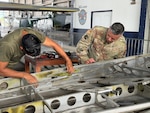 U.S. Air Force Tech. Sgt. Nestor Rivera, aircraft structural maintenance instructor, 156th Tactical Advisory Squadron, Puerto Rico Air National Guard, assesses corrosion damage on the wing of a Cessna 172 at Panama City, Panama, March 16, 2026. (U.S. Air National Guard courtesy photo)