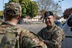 U.S. Air Force Maj. Gen. Thomas Sherman, Air Force Installation and Mission Support Center commander, speaks to Col. Scott Korell, 100th Operations Group commander, during a visit at RAF Mildenhall, England, April 22, 2026.
