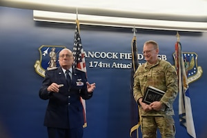 Civil Air Patrol Col. Tom Carello, former New York Wing commander, left, presents U.S. Air Force Col. John Meili, deputy wing commander of the 174th Attack Wing, New York Air National Guard, with the Frank G. Brewer Civil Air Patrol Memorial Award nomination on behalf of the wing for its contributions and partnership with Civil Air Patrol over the past three decades during a ceremony at Hancock Field Air National Guard Base, Syracuse, N.Y., April 18, 2026. The award recognizes organizations for outstanding support of Civil Air Patrol programs. (Courtesy photo via Civil Air Patrol)