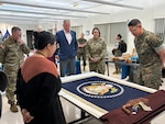 Sergeant Major of the Marine Corps Carlos Ruiz examines a nearly completed Presidential flag during a visit to Defense Logistics Agency Troop Support in Philadelphia on April 27. His visit included a tour of the flag room.