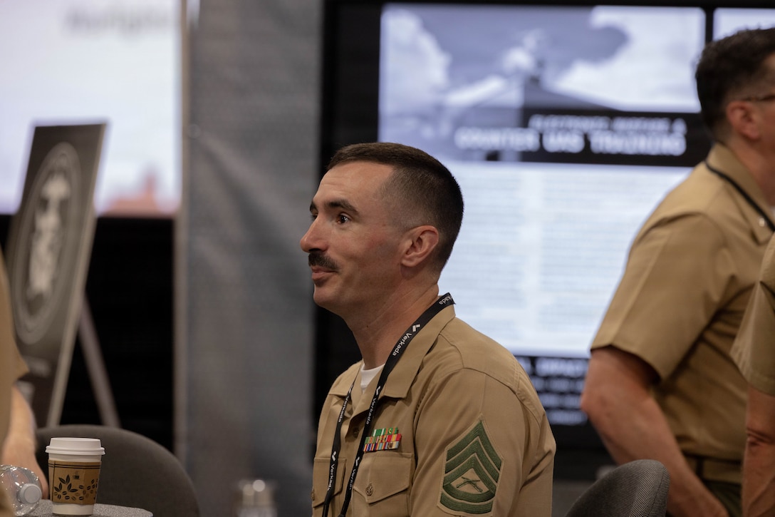 U.S. Marine Corps Gunnery Sgt. Travis VonSchimidt, Marine Innovation Unit Marine Innovator, discusses on how the Marine Innovation Unit partners with Combat Development & Integration and Marine Corps Warfighting Laboratory to support the units and organizations across the Marine Corps, during the Modern Day Marine 2026, Walter E. Washington Convention Center, Washington, DC, April 29, 2026. Modern Day Marine brings together representatives from military, industry and government to collaborate in shaping the future of the United States Marine Corps. Through the interactions taking place at Modern Day Marine, the Corps is able to engage, educate and increase understanding of the Marine Corps' contributions to the National Defense Strategy. (U.S. Marine Corps photo by Cpl. Carlina Holland)