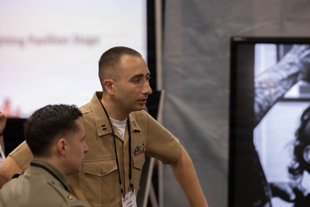 U.S. Marines Corps Capt. Loui Freda, Marine Innovation Unit Innovation Officer, discusses the Marine Innovation Unit and how the unit partners with Combat Development & Integration and Marine Corps Warfighting Laboratory to support the units and organizations across the Marine Corps, during Modern Day Marine 2026, Walter E. Washington Convention Center, Washington, DC, April 29, 2026. Modern Day Marine brings together representatives from military, industry and government to collaborate in shaping the future of the United States Marine Corps. Through the interactions taking place at Modern Day Marine, the Corps is able to engage, educate and increase understanding of the Marine Corps' contributions to the National Defense Strategy. (U.S. Marine Corps photo by Cpl. Carlina Holland)
