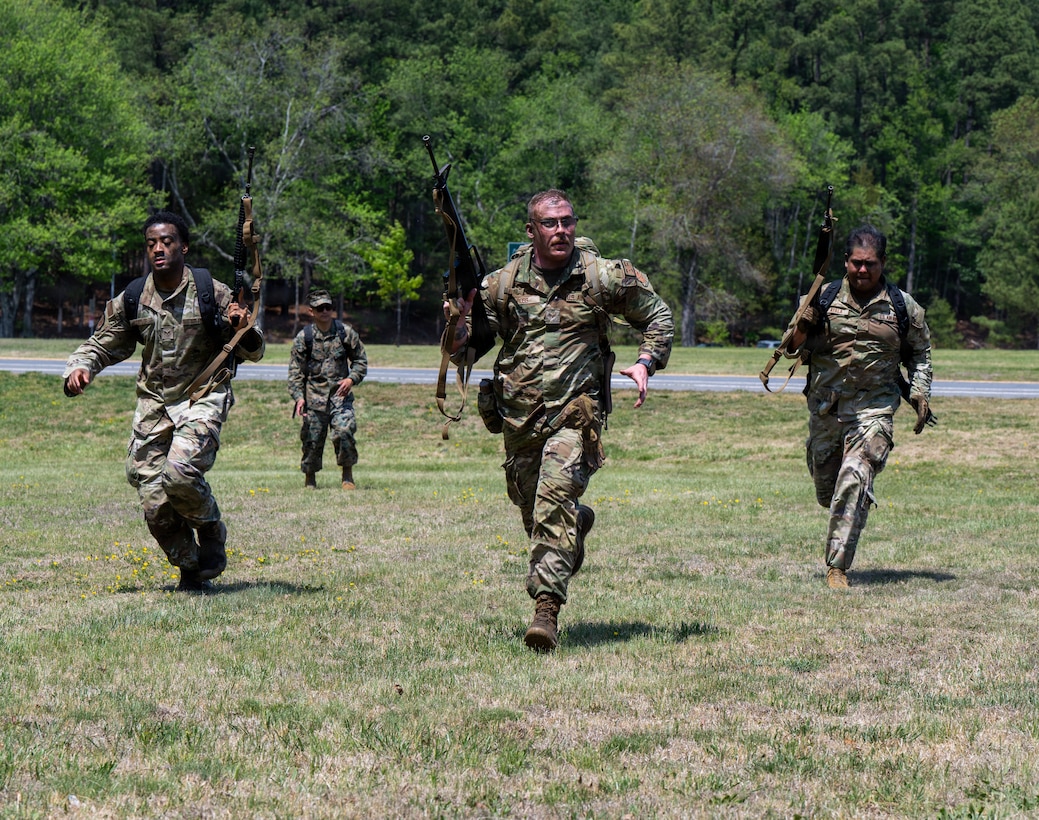 U.S. Air Force Airmen charge for their next position during a field training exercise at Marine Corps Base Quantico, Virginia, April 24, 2026.