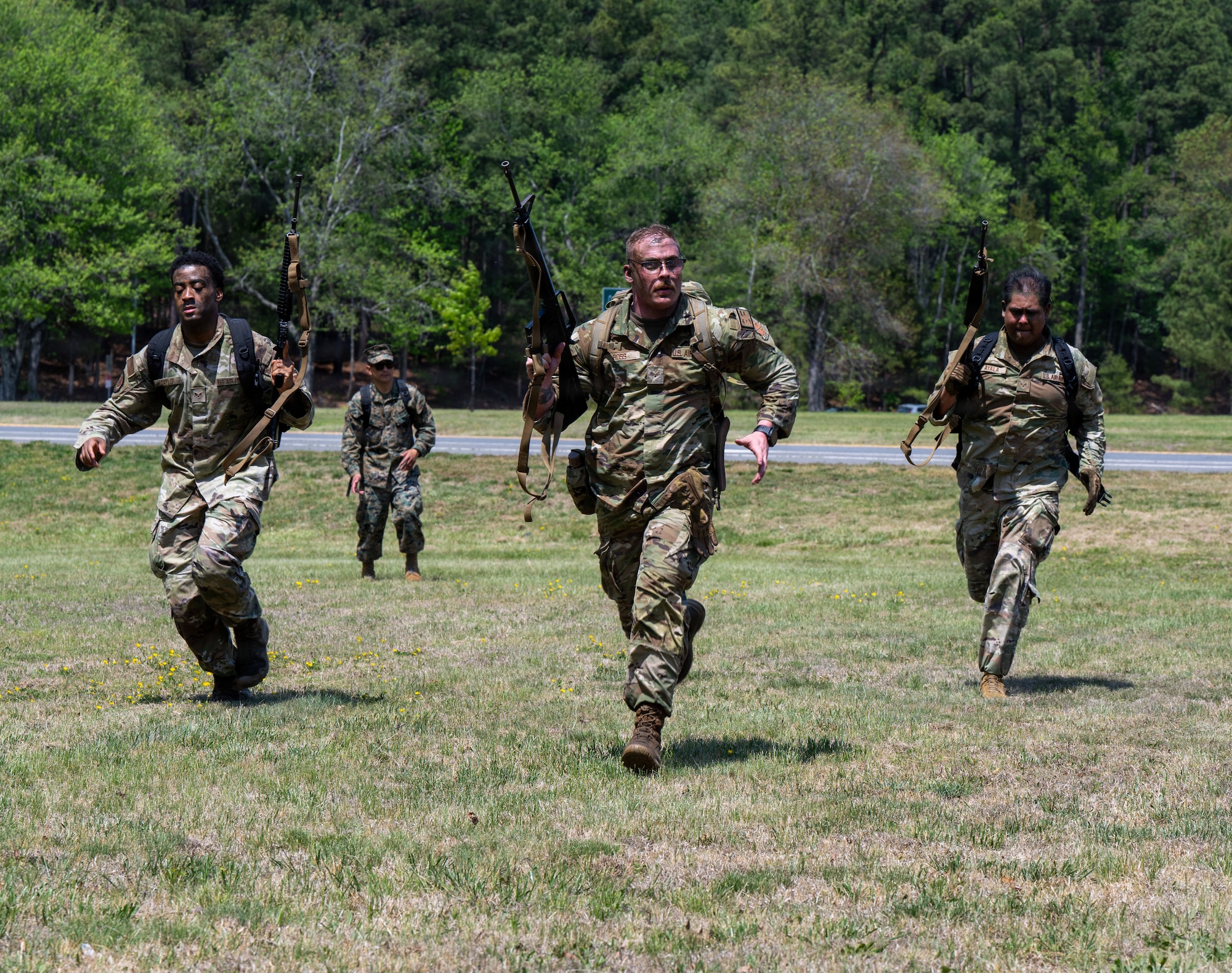 U.S. Air Force Airmen charge for their next position during a field training exercise at Marine Corps Base Quantico, Virginia, April 24, 2026.
