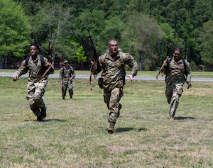 U.S. Air Force Airmen charge for their next position during a field training exercise at Marine Corps Base Quantico, Virginia, April 24, 2026.