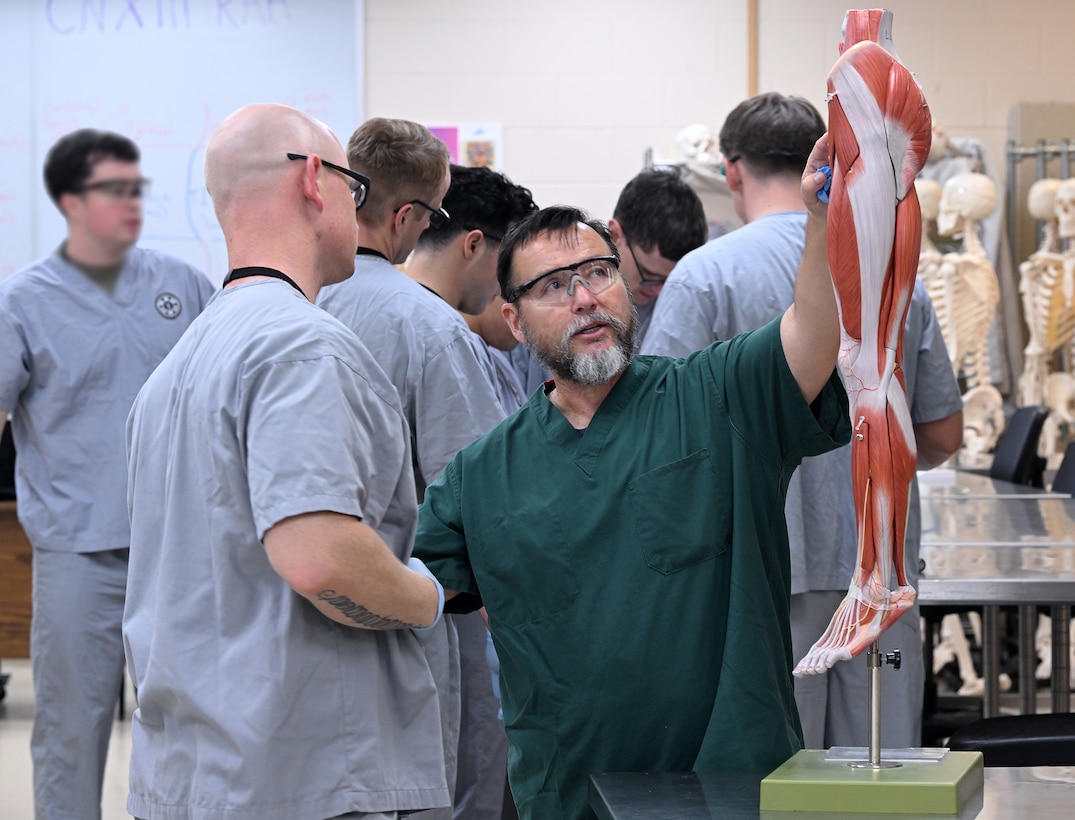 An instructor from the Joint Special Operations Medical Training Center at the U.S. Army John F. Kennedy Special Warfare Center and School provides instruction to students in the Special Operations Combat Medic Course on the human skeletal and muscular system during training at Fort Bragg, North Carolina May 1, 2025. Enlisted service members who completed the course specialize in trauma management, infectious diseases, cardiac life support and surgical procedures and qualify as highly trained combat medics with the skills necessary to provide initial medical and trauma care and to sustain a casualty for up to 72 hours. (U.S. Army photo by K. Kassens)