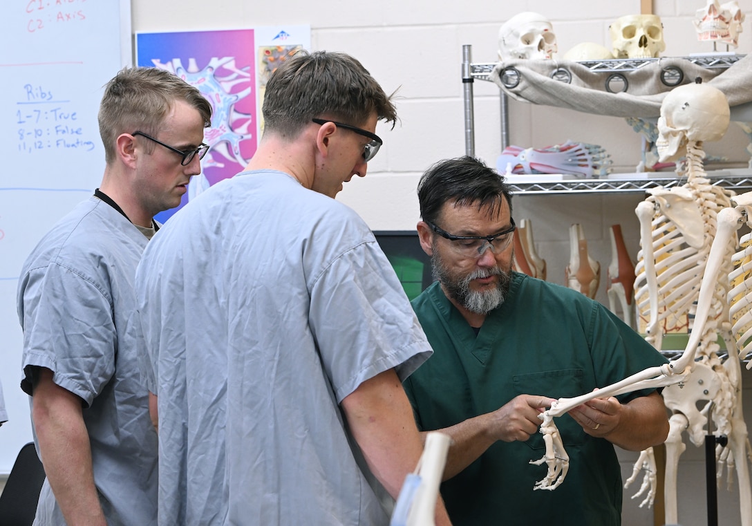 An instructor from the Joint Special Operations Medical Training Center at the U.S. Army John F. Kennedy Special Warfare Center and School provides instruction to students in the Special Operations Combat Medic Course on the human skeletal and muscular system during training at Fort Bragg, North Carolina May 1, 2025. Enlisted service members who completed the course specialize in trauma management, infectious diseases, cardiac life support and surgical procedures and qualify as highly trained combat medics with the skills necessary to provide initial medical and trauma care and to sustain a casualty for up to 72 hours. (U.S. Army photo by K. Kassens)