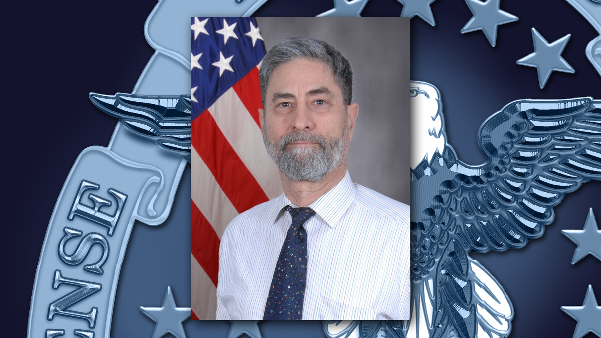 Graphic featuring an official photo of a man with a gray beard, wearing a buttoned shirt and tie