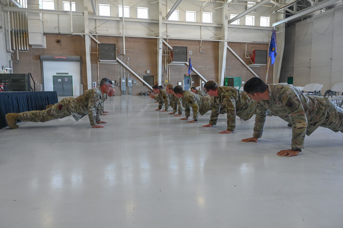 U.S. Air Force Col. Jose Cabrera, 355th Wing commander, left, and members of the 563d Rescue Group conduct ceremonial memorial pushups during a Presidential Unit Citation ceremony at Davis-Monthan Air Force Base, Arizona, April 17, 2026. The pushups honored the contributions of the 55th and 48th Rescue Squadrons during the final withdrawal of U.S. troops from Afghanistan, which resulted in the evacuation of thousands of American citizens and Afghan refugees between July 16 and Aug. 31, 2021. (U.S. Air Force photo by Staff Sgt. Kahdija Slaughter)