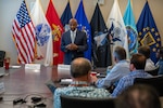 Man speaks at table.