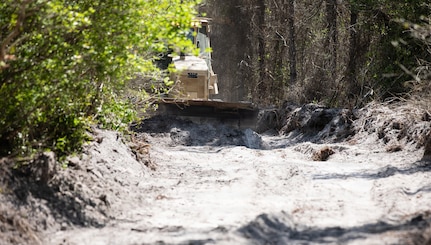 A bulldozer crew with 877th Engineer Company, 878th Engineering Battalion, 648th Maneuver Enhancement Brigade, Georgia National Guard helps clear burnt brush in support of wildland fire suppression efforts in Pineland, Georgia, April 29, 2026.