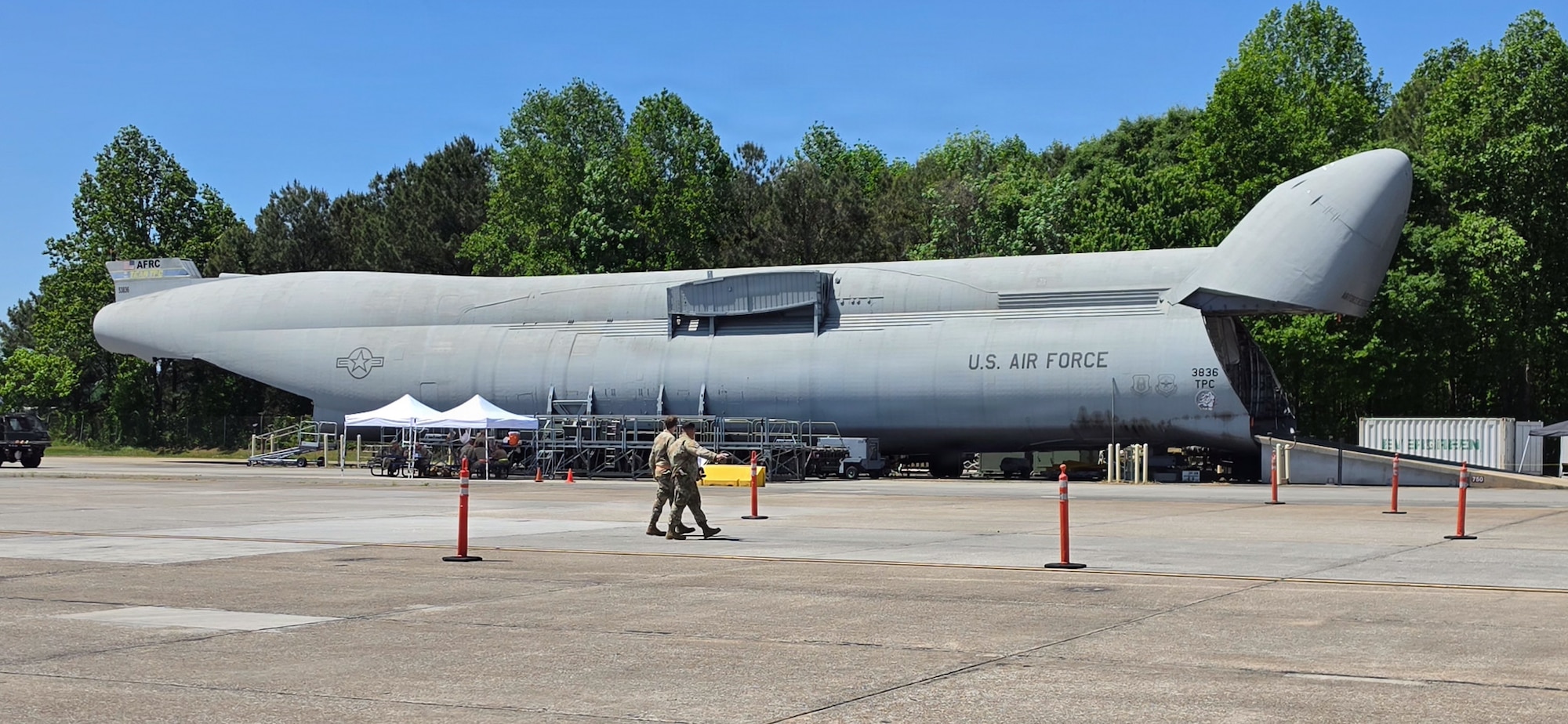Three Airmen working on a pallet and equipment.
