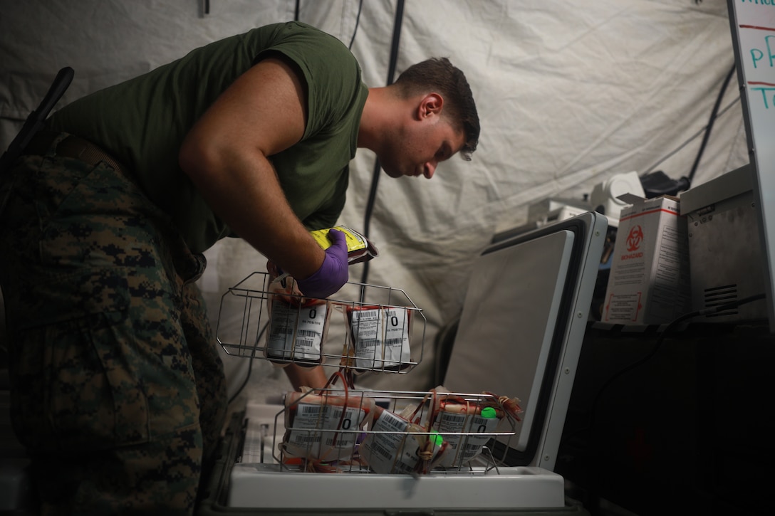 U.S. Navy Petty Officer 2nd Class Seth Robinson, a laboratory technician with Combat Logistics Battalion 13, Combat Logistics Regiment 17, 1st Marine Logistics Group, and a native of Hurst, Texas, collects blood during a walking blood bank drill as part of Exercise Valiant Shield 24 at Camp Katuu, Palau, June 8, 2024. Valiant Shield is a multinational, biennial field training exercise focused on interoperability in a multi-domain environment. I Marine Expeditionary Force conducts exercises like Valiant Shield to enhance interoperability with allied and partner forces and expand the operational capability of the Marine Air-Ground Task Force in the Indo-Pacific region. (U.S. Marine Corps photo by Lance Cpl. Hannah Hollerud)