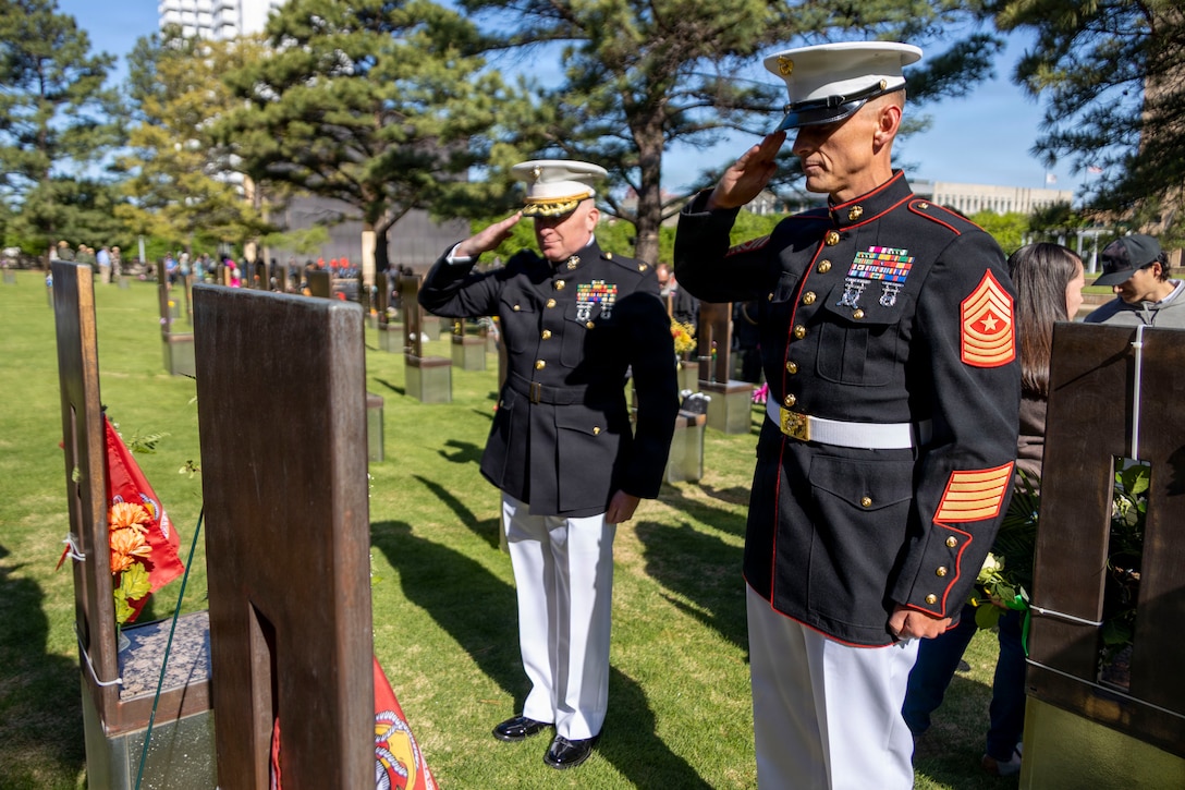 U.S. Marine Corps Maj. Darryl Gravelle, center, the Recruiting Station Oklahoma City commanding officer, and Sgt. Maj. Daniel Jacobson, right, the Recruiting Station Oklahoma City sergeant major, salute memorials to two Marines following the 31st annual remembrance ceremony at the Oklahoma City National Memorial and Museum in Oklahoma City, Oklahoma, April 19, 2026. The ceremony marks the anniversary of the bombing and honors the 168 victims, including two U.S. Marines, Capt. Randolph Guzman and Sgt. Benjamin Davis, who were serving with Recruiting Station Oklahoma City at the time of the attack. (U.S. Marine Corps photo by Staff Sgt. Lennon Dregoiw)