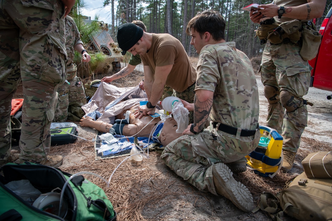 FORT BRAGG, N.C. (Feb. 16, 2023) – Students in the Special Operations Combat Medic Course at the U.S. Army John F. Kennedy Special Warfare Center and School simulate casualty care with high fidelity manikins and using hyper realistic special effects makeup called moulage during training at Fort Bragg, North Carolina Feb. 16, 2023. NSOMI, a detachment of NMOTC, specializes in training the enlisted service members and medical providers who support US special operations. Enlisted service members who completed the courses will specialize in trauma management, infectious diseases, cardiac life support and surgical procedures, with a basic understanding of veterinary medicine and dental medicine. Navy Medicine Operational Training Command (NMOTC) is comprised of six nationwide detachments that offer specialized medical training in the fields of aviation, aviation survival, surface and undersea warfare, expeditionary and special operations medicine. (U.S. Navy Photo by Mass Communication Specialist 2nd Class Russell Lindsey)
