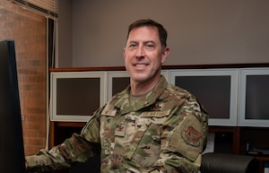 Col Meyer at his desk in his office.