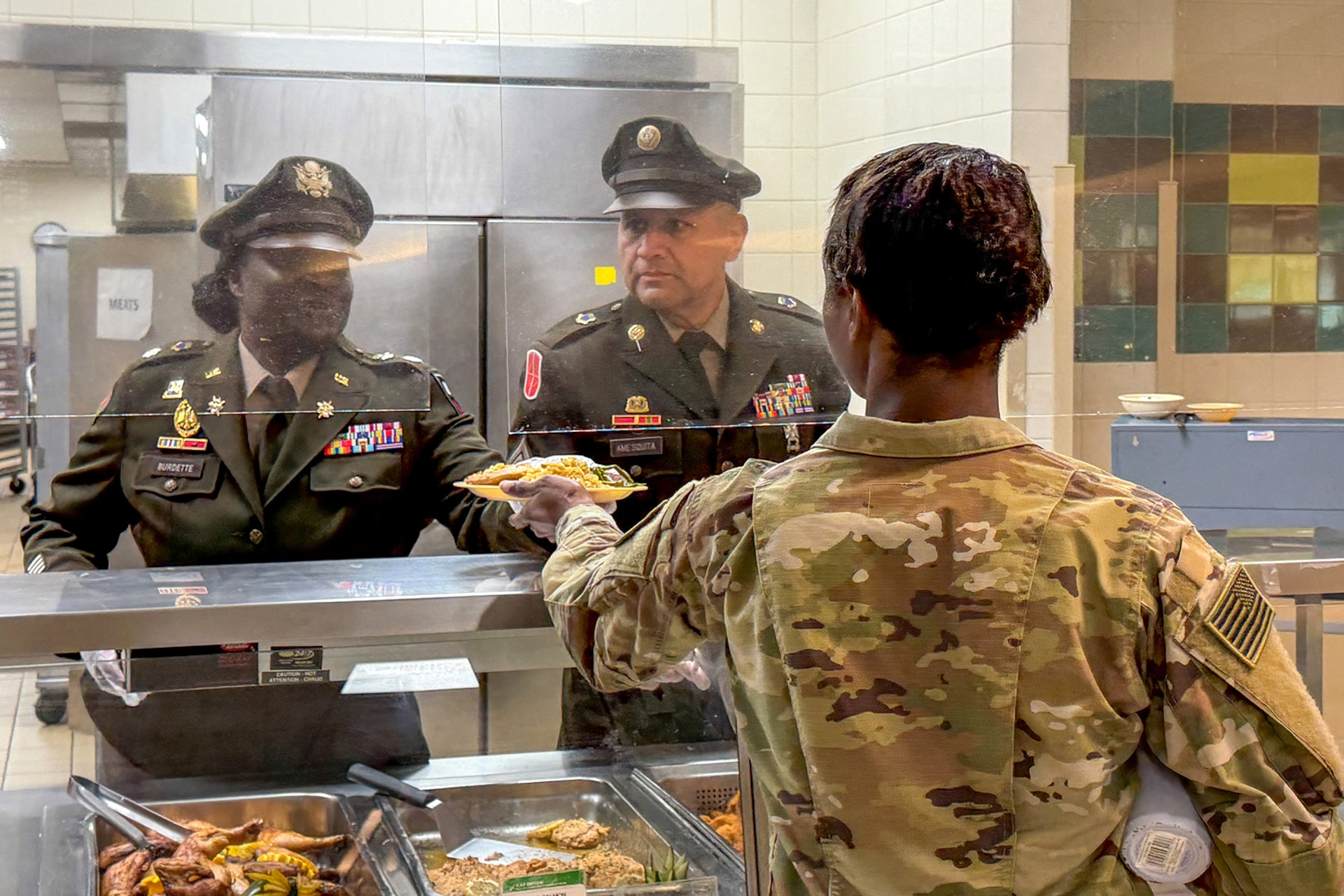 Lt. Col. Kemetta G. Burdette, left, Commander, 1-347th Training Support Battalion, and Command Sgt. Maj. Eduardo Amesquita, Command Sergeant Major, 1-347th TSBN, serve food at the North Fort Hood Dining Facility on April 23, 2026, as part of the U.S. Army Reserve's 118th birthday celebration.