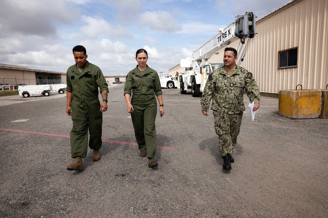 U.S. Marine Corps Sgt. Christopher Canaleshall of Clewiston, Florida, and Sgt. Sarah Soucie of Eureka, Missouri, aviation mechanics designated as quality assurance representatives with Blount Island Command, discuss tire maintenance on a wheeled crane with Navy Petty Officer 1st Class Matthew Abdoran, a ground support equipment instructor, during training April 30 at Naval Air Station Jacksonville, Florida. The training requalified Marines in aviation support equipment tire and wheel maintenance in support of maritime prepositioning readiness. (U.S. Marine Corps photo by Dustin Senger)