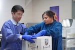 SAN DIEGO (April 11, 2026) David Chou , principal  investigator of the ‘A Virtual Astronaut Tissue Analog Response’ (AVATAR) investigation, and Erica Duarte, Lab Safety and Logistics Supervisor at Naval Health Research Center (NHRC), place extracted specimens into a secure package for transport, further tests and analysis. These specimens are being analyzed as part of NHRC, part of NASA’s Artemis II mission. Navy Medicine Research & Development, supports Navy, Marine Corps and joint U.S. warfighter health readiness and lethality with research and development that delivers high-value, high-impact solutions to the health and readiness challenges U.S. military population faces on the battlefield, at-sea, home and abroad. (U.S. Navy photo by Matthew Reyes/released)