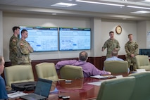 Photo of cadets briefing in a conference room