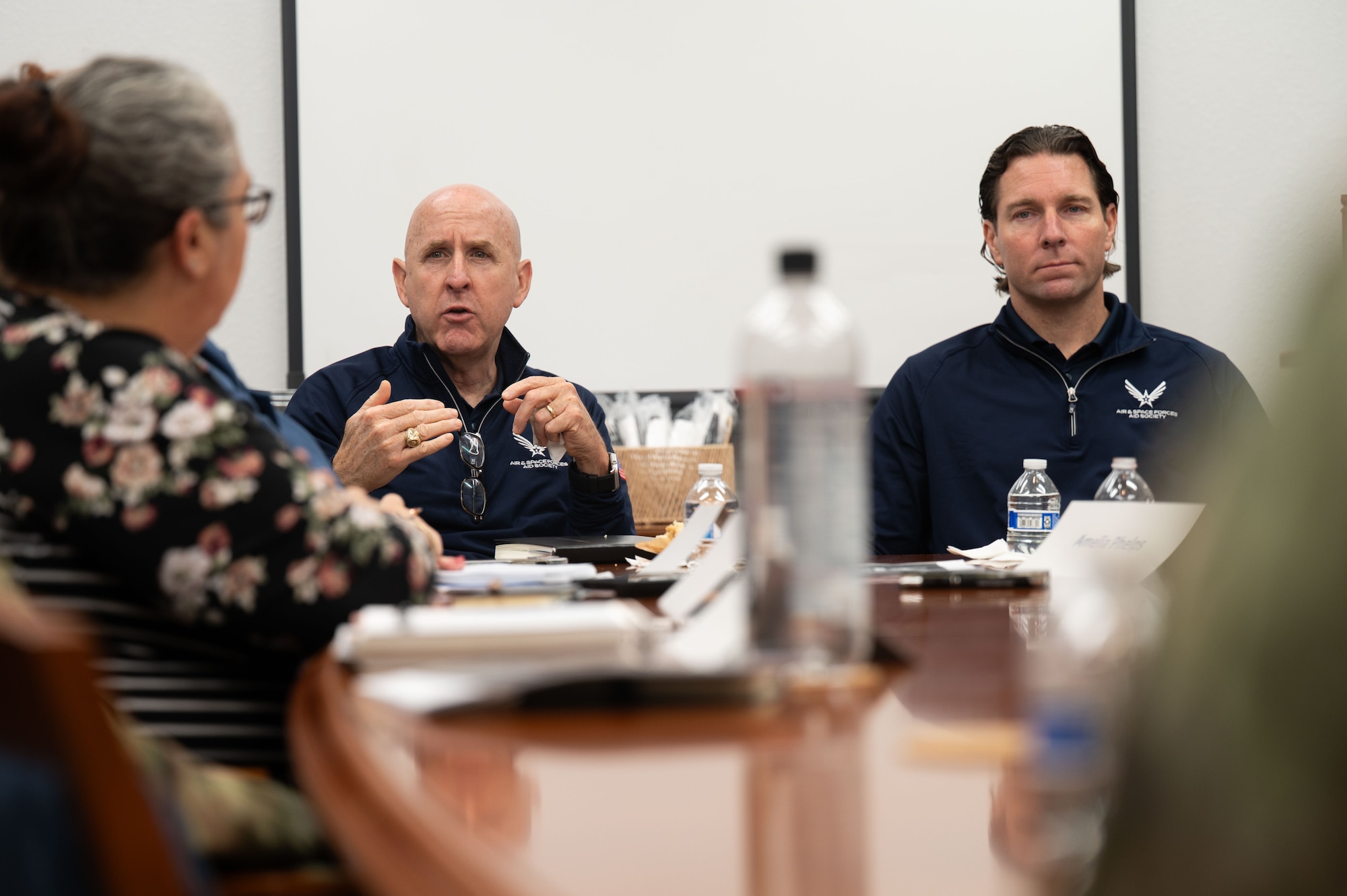 U.S. Air Force retired Maj. Gen. Ed Thomas, Air and Space Forces Aid Society chief executive officer, left, and Packy Lyden, AFAS chief development officer, right, speak with members of the  Military and Family Readiness Center at Davis-Monthan Air Force Base, Arizona, April 29, 2026. During the visit, AFAS leaders engaged with commanders, first sergeants and community partners to highlight resources available to Airmen and their families. (U.S. Air Force photo by Airman 1st Class Jaden Kidd)