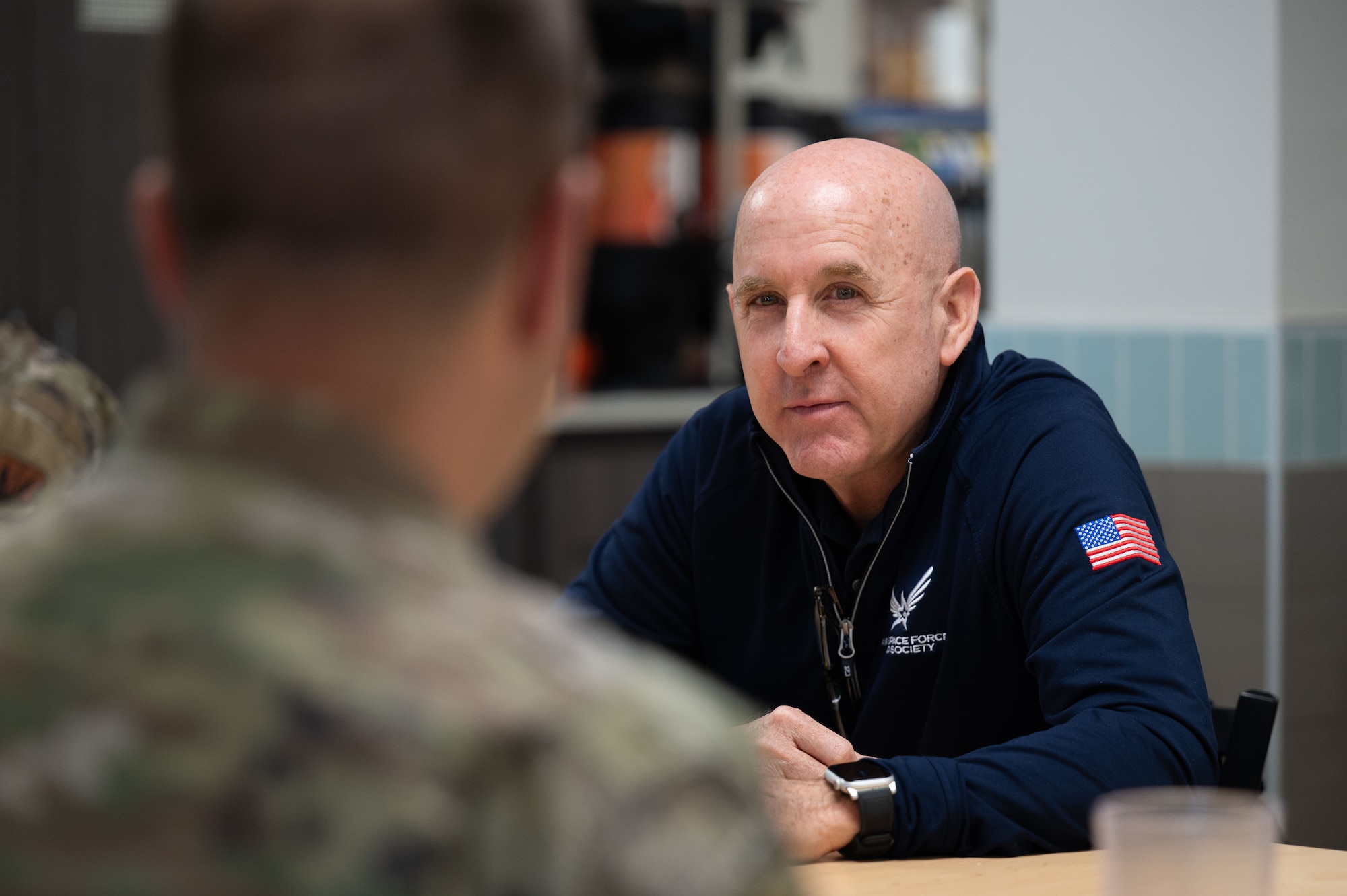 U.S. Air Force retired Maj. Gen. Ed Thomas, Air and Space Forces Aid Society chief executive officer, speaks with an Airman about AFAS programs at Davis-Monthan Air Force Base, Arizona, April 29, 2026,. AFAS offers support such as child care assistance during permanent change of station moves and car seat grants for junior enlisted families. (U.S. Air Force photo by Airman 1st Class Jaden Kidd)